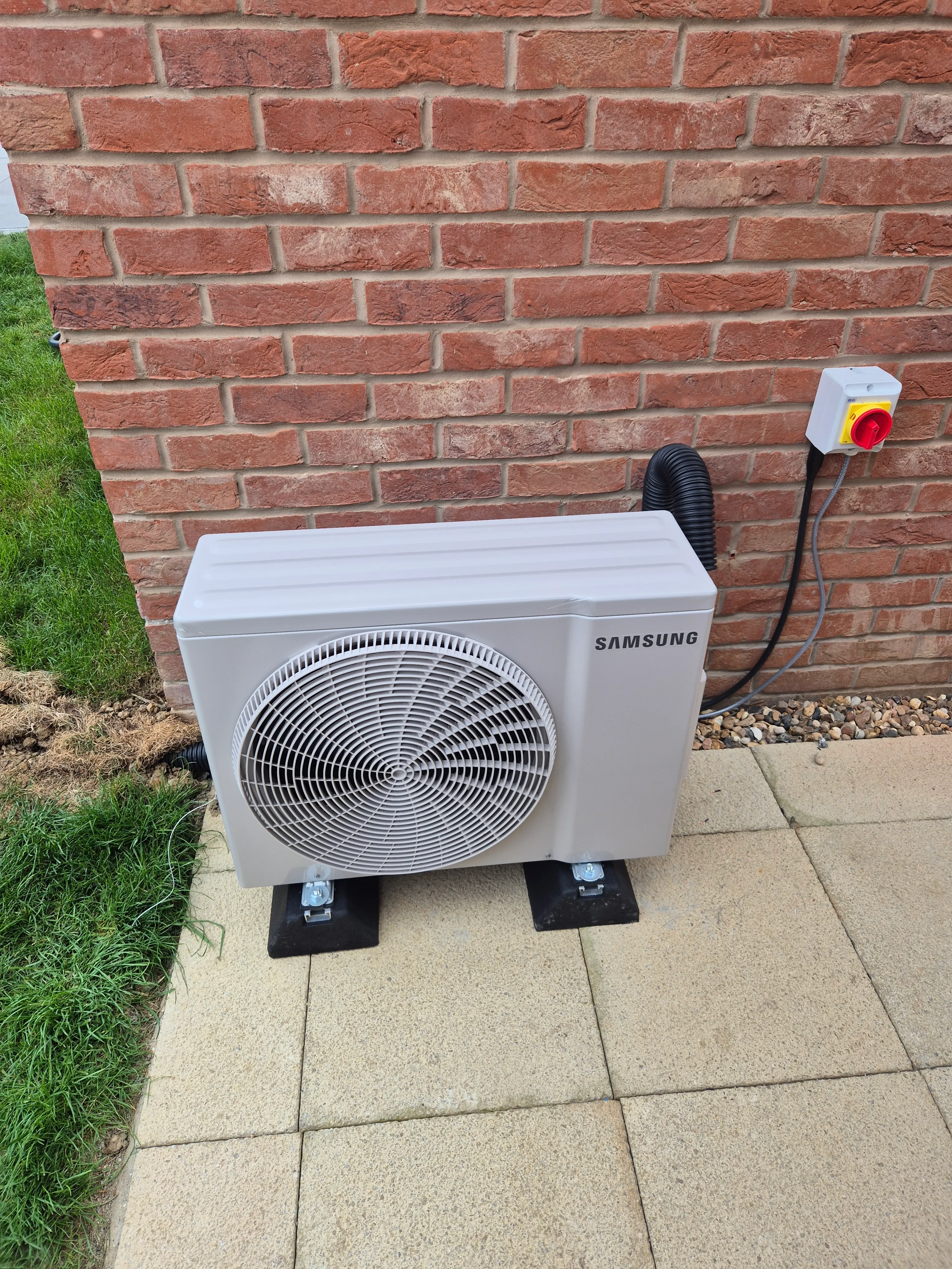 Samsung air conditioning indoor unit fitted on the wall, still in protective wrap