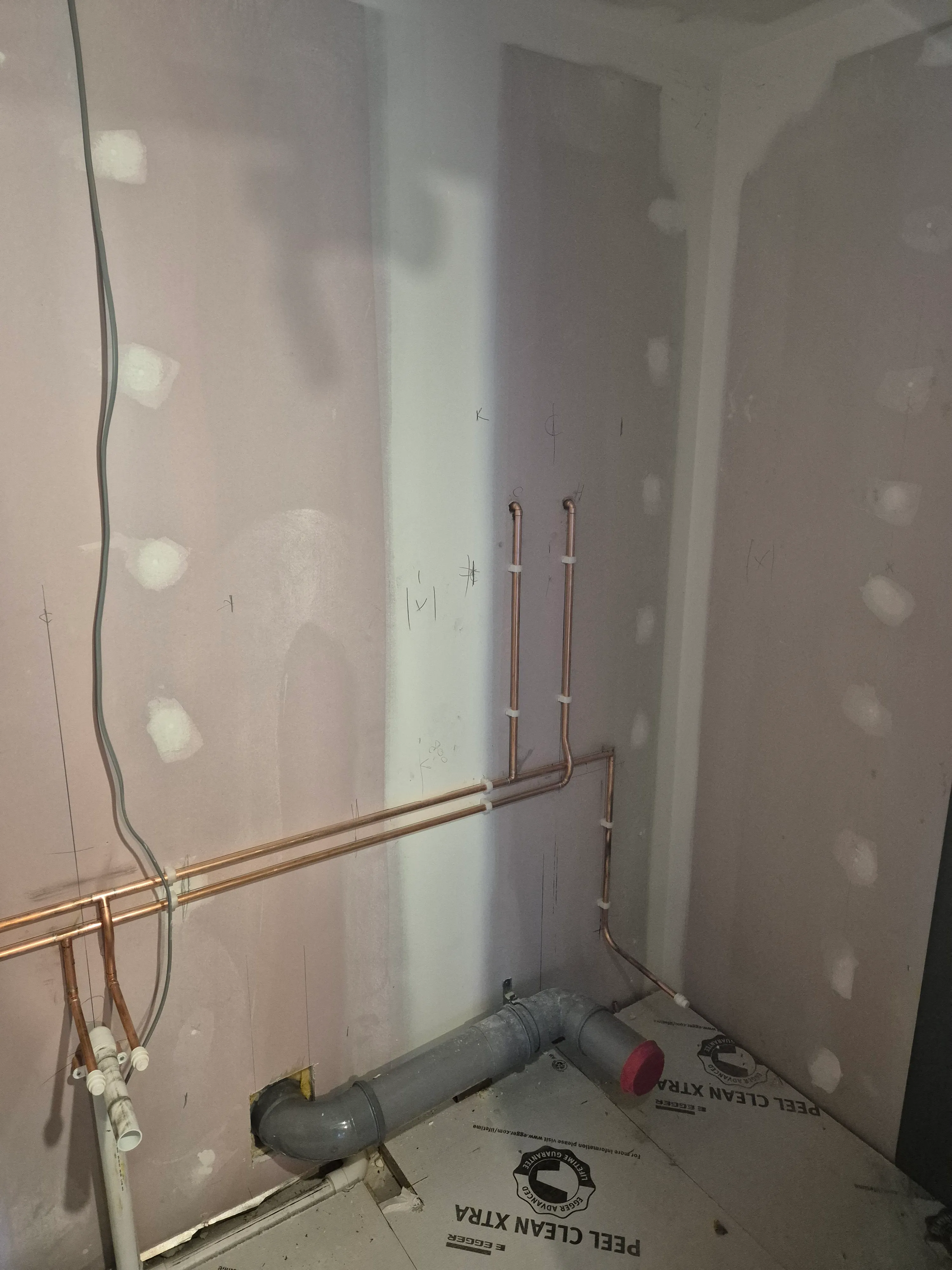 Refrigerant pipework and drainage running through the wall void