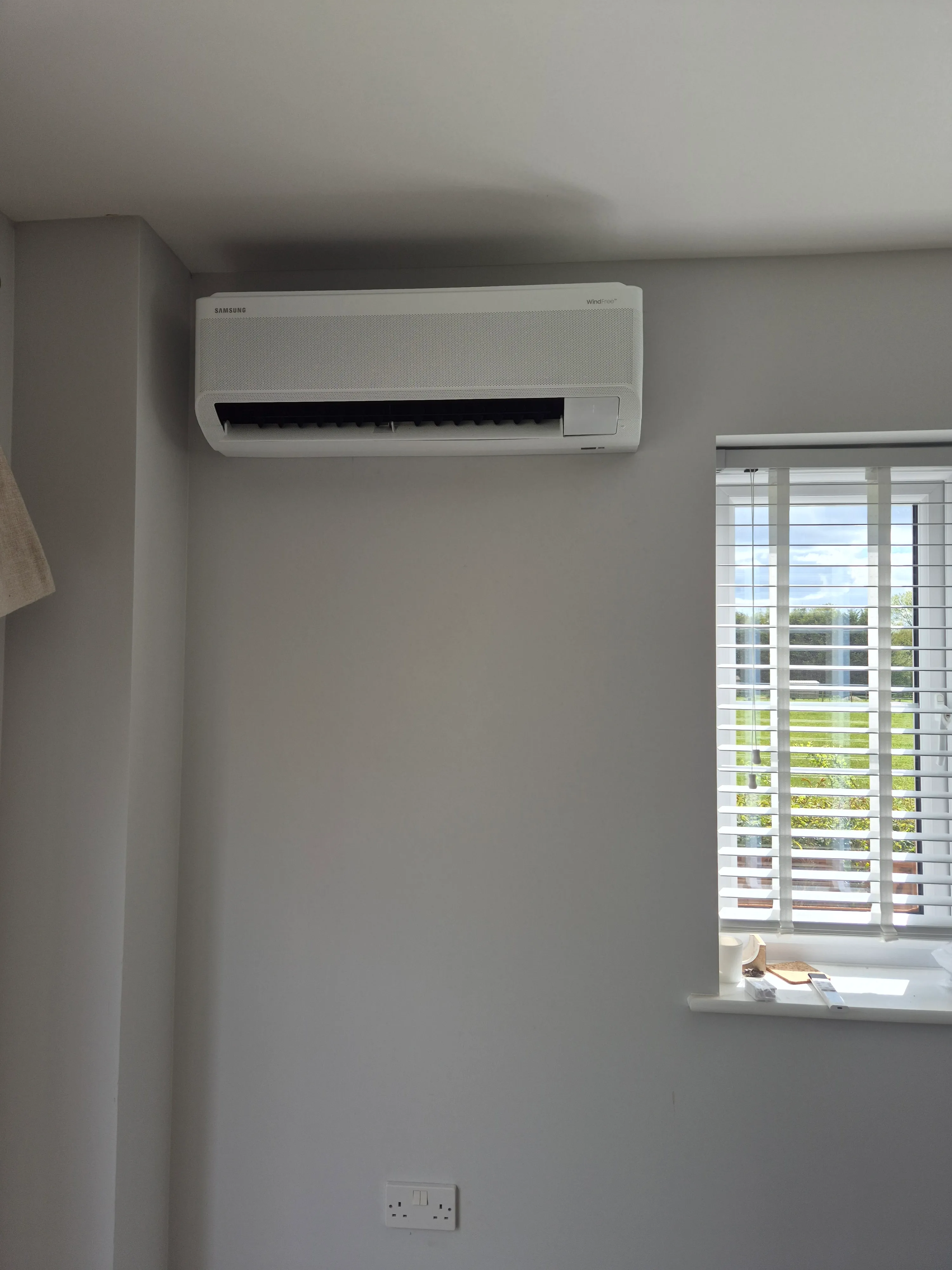 Samsung wall-mounted air conditioning unit fitted in a living room