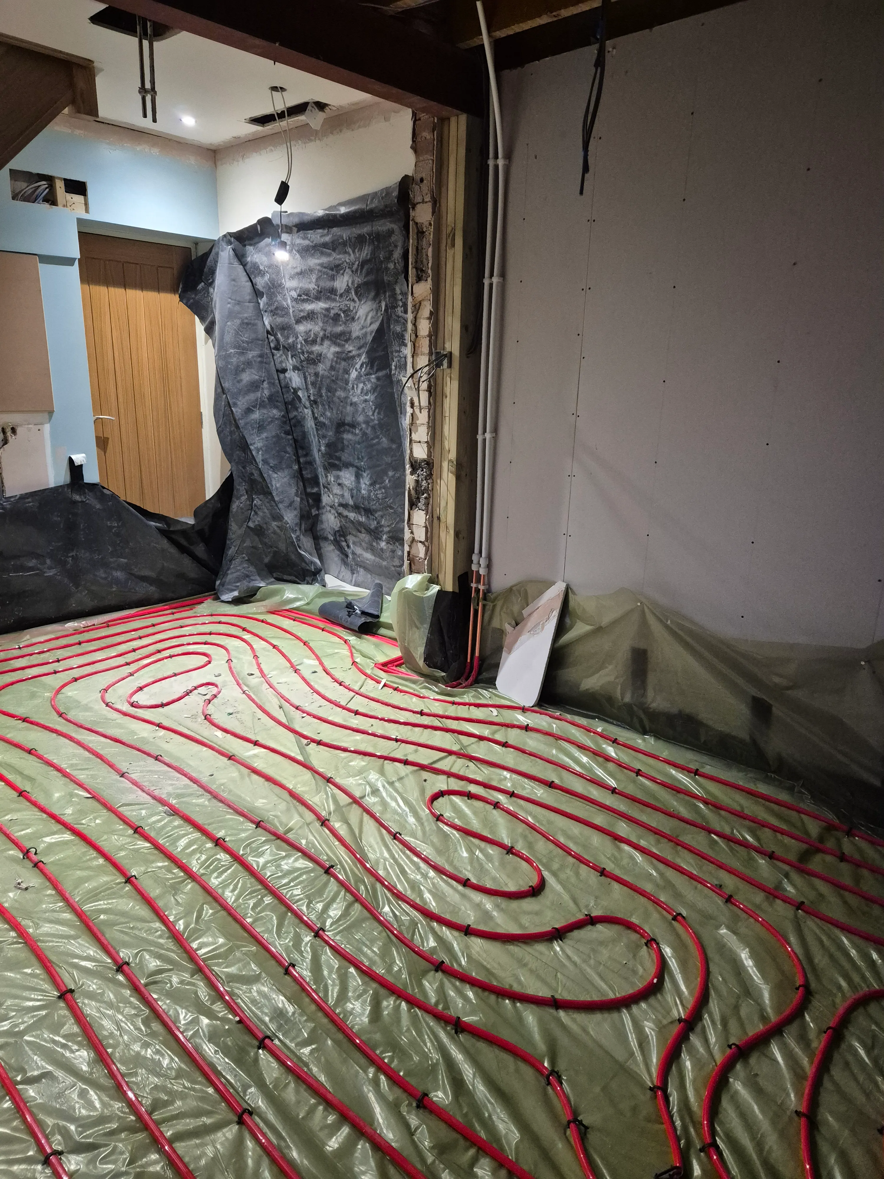 Underfloor heating loops — wide view of the finished pipework