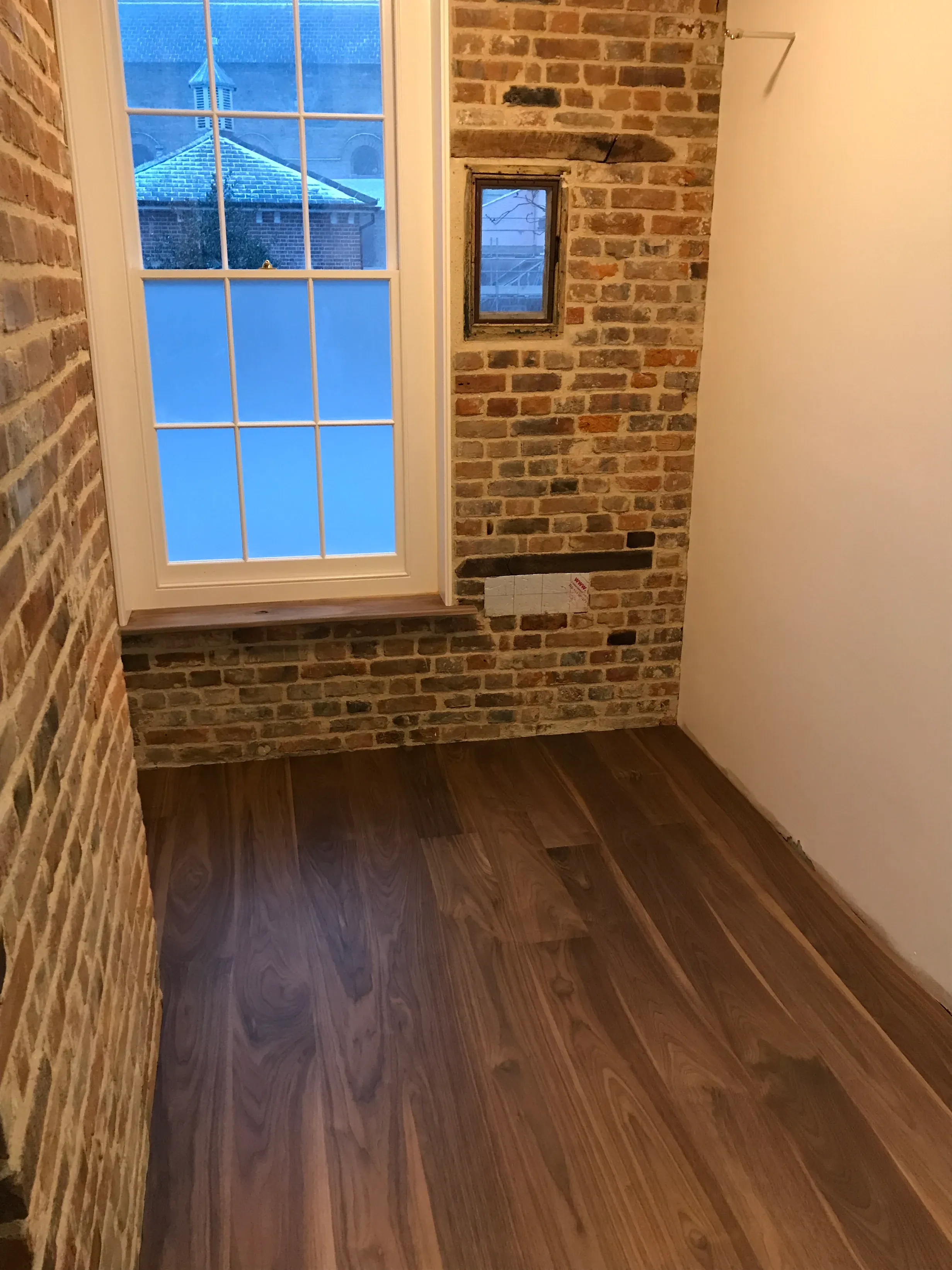 Finished walnut flooring after the heating and plumbing install